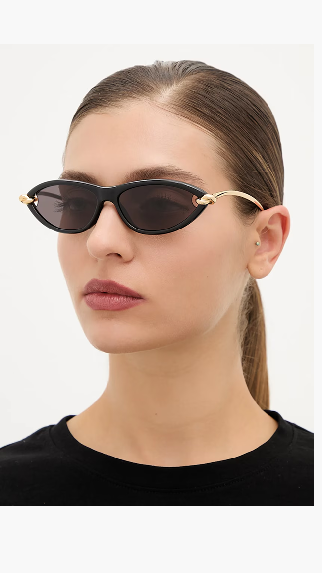 Model wearing black Bottega Veneta sunglasses.