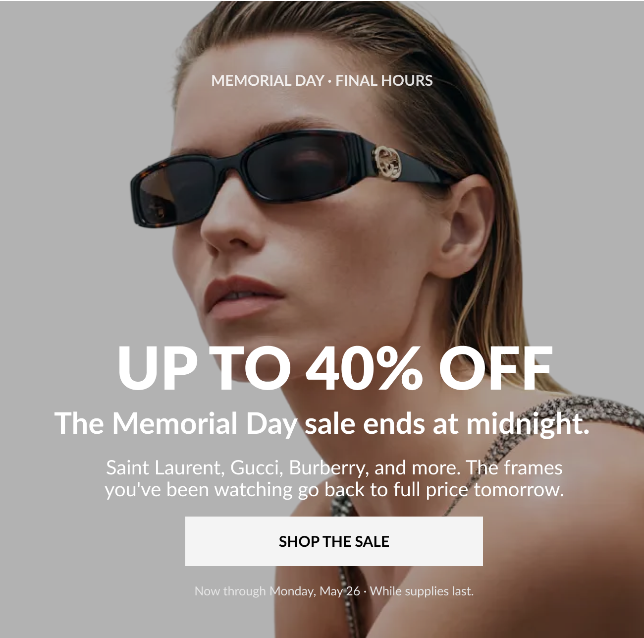 Model wearing black designer sunglasses with text overlay promoting a Memorial Day sale offering up to 40% off luxury eyewear brands including Saint Laurent, Gucci, and Burberry.