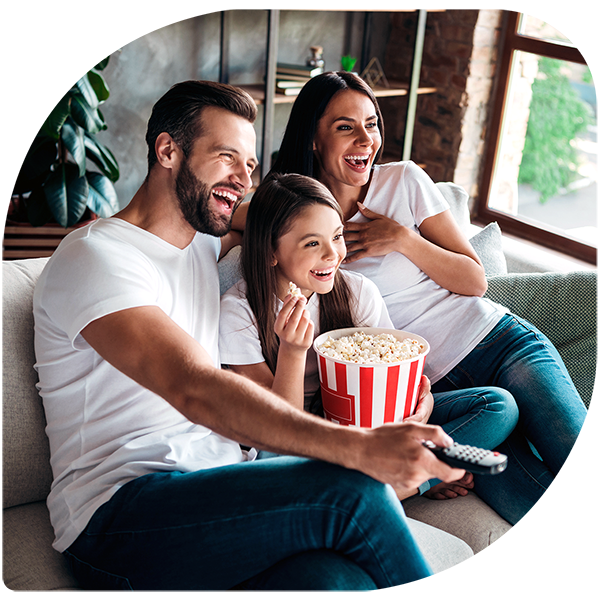 Portrait of cheerful cheery family  sitting on divan having fun watching video switching channel spending free time