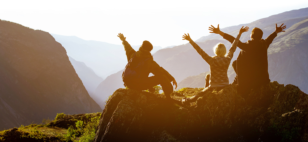 Happy friends having fun at sunset time in mountains range backdrop.