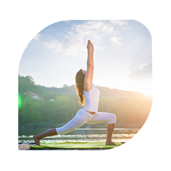 Woman doing yoga on the lake - beautiful lights