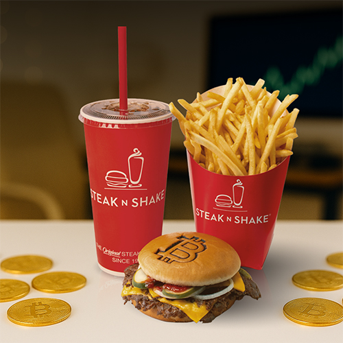 Steak ’n Shake meal with steakburger, fries, and drink; burger bun has Bitcoin logo, surrounded by gold Bitcoin coins 