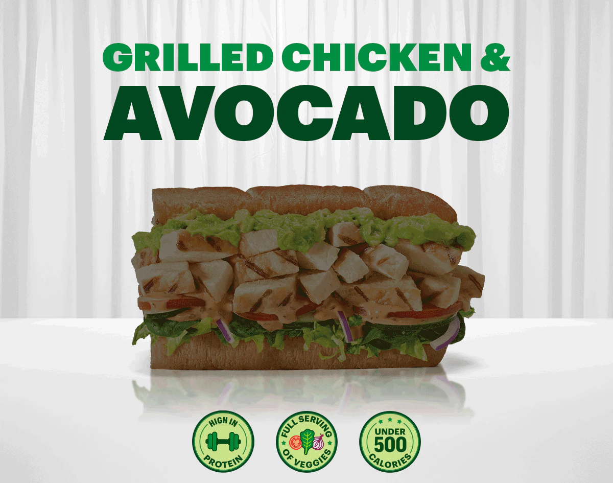 Grilled chicken and avocado sandwich on multigrain bread with veggies, highlighted as a Fresh Fit® option, under 500 calories, high protein, and full serving of vegetables.