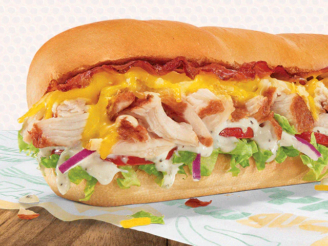 Subway® promotion featuring a footlong sandwich. Text reads 'Ready. Set. BOGO1 Go for 2. Buy 1 footlong + get 1 for $1. Use code: BOGO1.' Image conveys value and freshness.