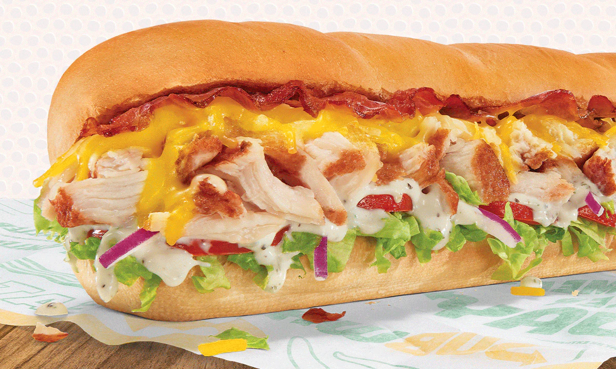 Subway® promotion featuring a footlong sandwich. Text reads 'Ready. Set. BOGO1 Go for 2. Buy 1 footlong + get 1 for $1. Use code: BOGO1.' Image conveys value and freshness.