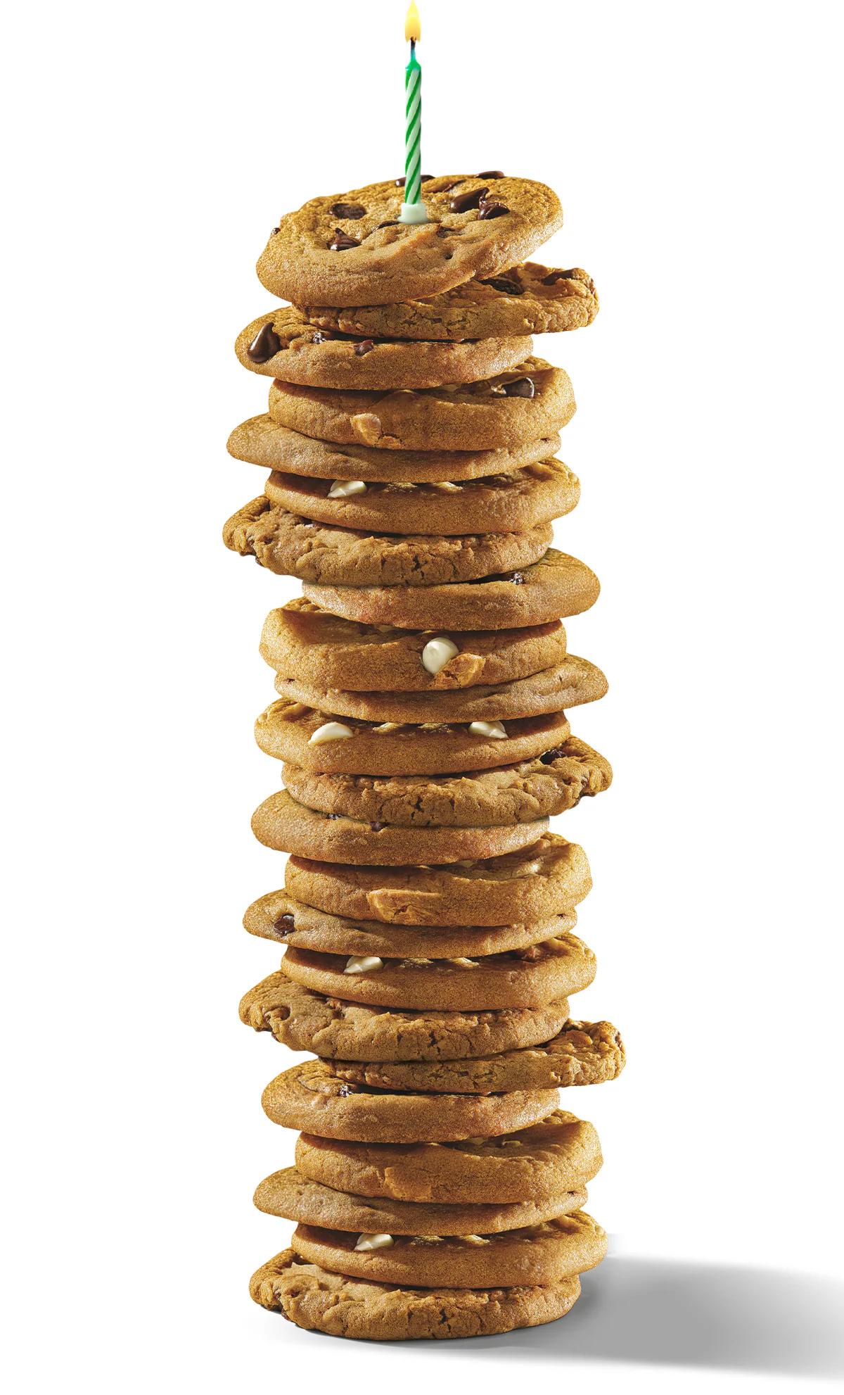 A tall stack of chocolate chip cookies with a lit candle on top celebrates a birthday. Musical notes surround green birthday text, adding a festive touch.