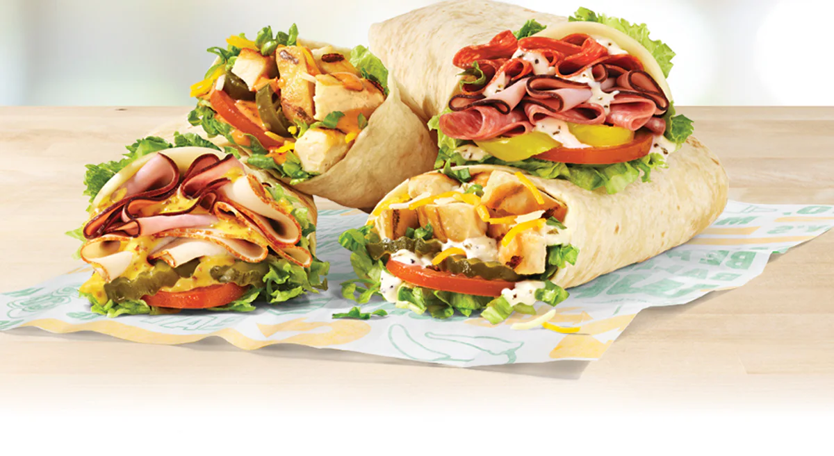 Promotional email announcing Subway’s new Protein Pockets. Header reads: ‘Sub Club Preview: Introducing Protein Pockets’. Hero image shows freshly prepared Protein Pockets on a countertop with vibrant ingredients and a variety of sauces. Two prominent badges highlight ‘High Protein’ and ‘Great Price.’ Call-to-action button says ‘Order Now.’ Layout is clean and food-forward, emphasizing affordability and freshness.