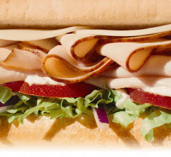 A promotional graphic for Subway’s Sub of the Day. The top section shows the price $4.99 for the Oven‑Roasted Turkey sub with a yellow button labeled ‘Seize the Deal.’ Below it reads ‘Oh My Gobble, It’s Turkey Thursday’ with a short description of the 6‑inch oven‑roasted turkey sub. Further down, a weekly Sub of the Day calendar lists: Meatball Monday, Tuna Tuesday, Sweet Onion Teriyaki Wednesday, Turkey Thursday (highlighted in green), Black Forest Ham Friday, Savory B.M.T. Saturday, and Spicy Italian Sunday. An image of multiple subs appears aligned with each day. A second ‘Seize the Deal’ button appears at the bottom.