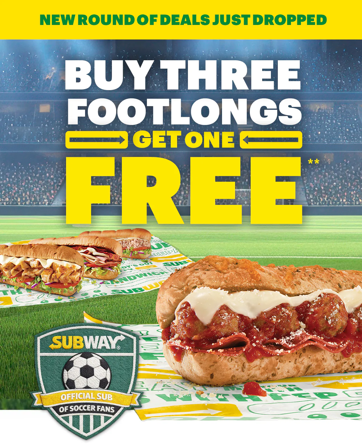 Promotional Subway® email promoting new deals now available in your App. Top banner reads “New round of deals just dropped.” Large headline in bold yellow and white text reads “Buy three footlongs, get one free.” Image shows multiple footlong subs on Subway-branded wrapper. Below, smaller text explains a weekly select offer and references a “buy 3 get 1 footlong free” deal, followed by a yellow button labeled “Order in app.” Next section reads “Watch out for more deals in the app” and highlights menu items labeled “The Favorite” with a $7.99 price and “The Double Play.” Bottom section features a green background with two people sitting and holding subs, alongside a smartphone displaying the Subway® app. Text reads “Soccer is on, time for a sub,” “Sub Club,” and “Check the app for new deals,” with a button labeled “See new deals.”