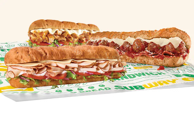 Promotional Subway® email showing an in‑restaurant offer for twenty percent off a sub. A QR code labeled "scan" appears in the center, with images of three Footlong subs below. Text notes the deal is available in-restaurant only and requires scanning the QR code to redeem on a sub, wrap, salad or bowl.
