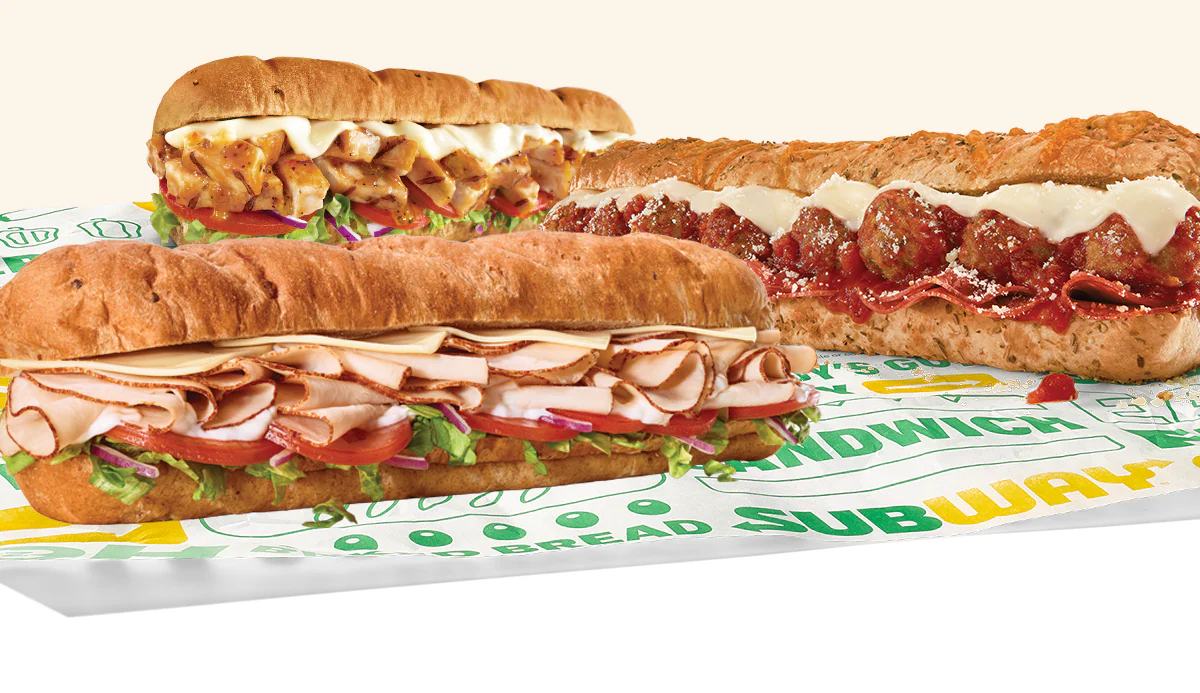 Promotional Subway® email showing an in‑restaurant offer for twenty percent off a sub. A QR code labeled "scan" appears in the center, with images of three Footlong subs below. Text notes the deal is available in-restaurant only and requires scanning the QR code to redeem on a sub, wrap, salad or bowl.