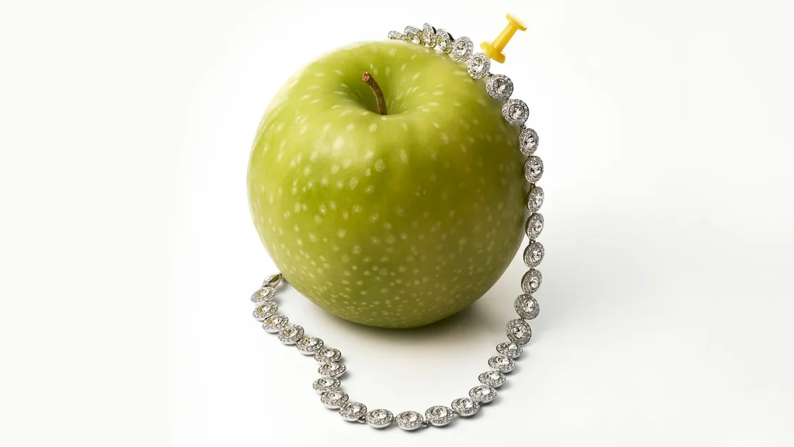 Una Angelic necklace on a green apple