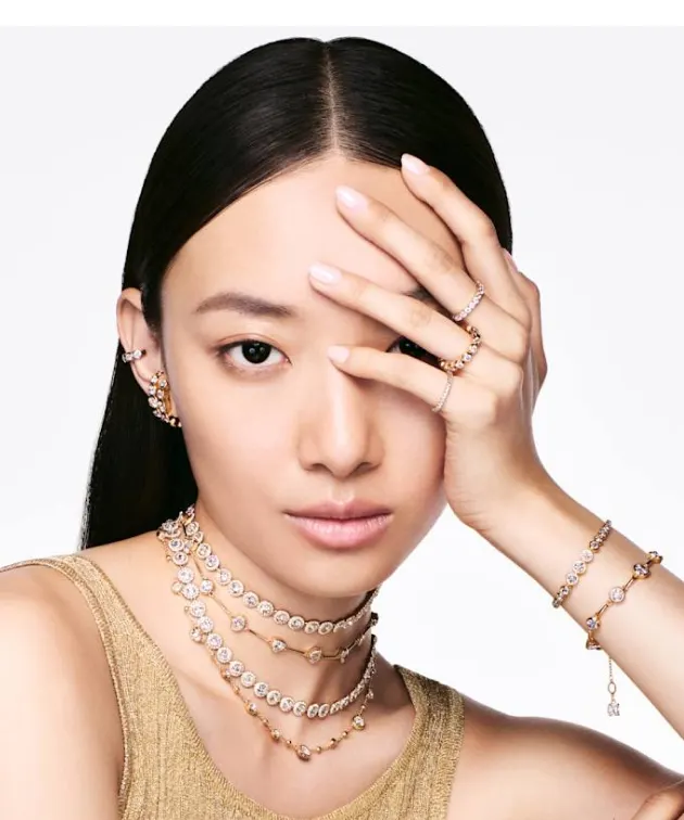 A model wearing Swarovski bracelets and rings