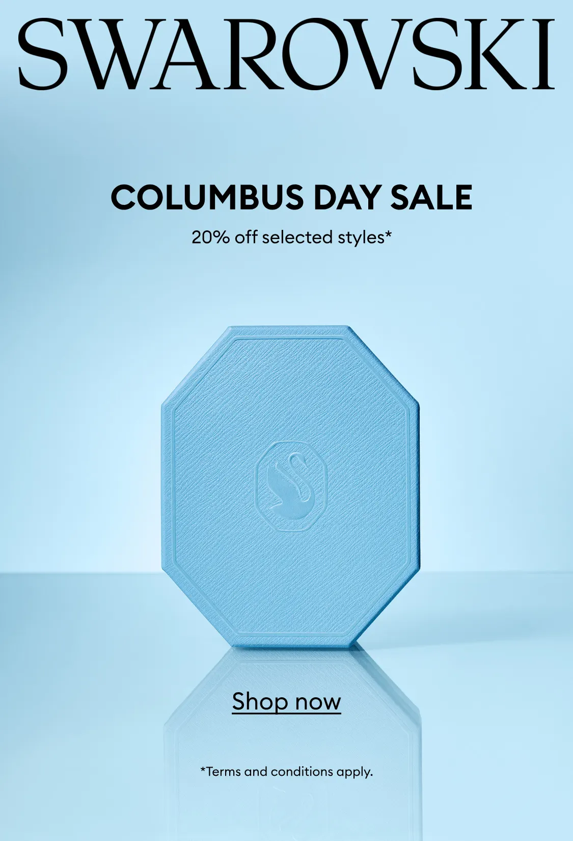 A blue Swarovski gift box on a blue background. Text reads: SWAROVSKI COLUMBUS DAY SALE 20% off select styles*