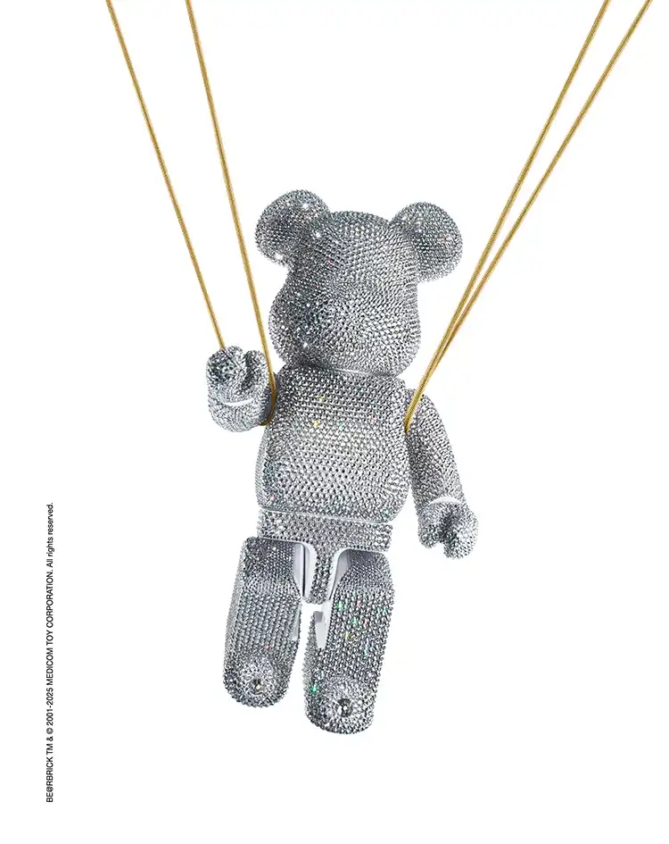 Crystallized bear hanging from cords