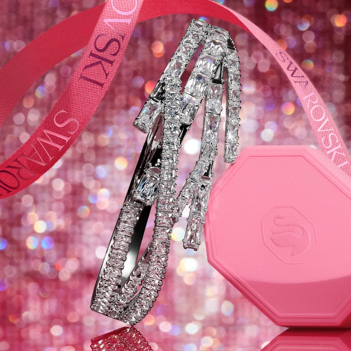 Swarovski bracelets and pink gift box on pink background