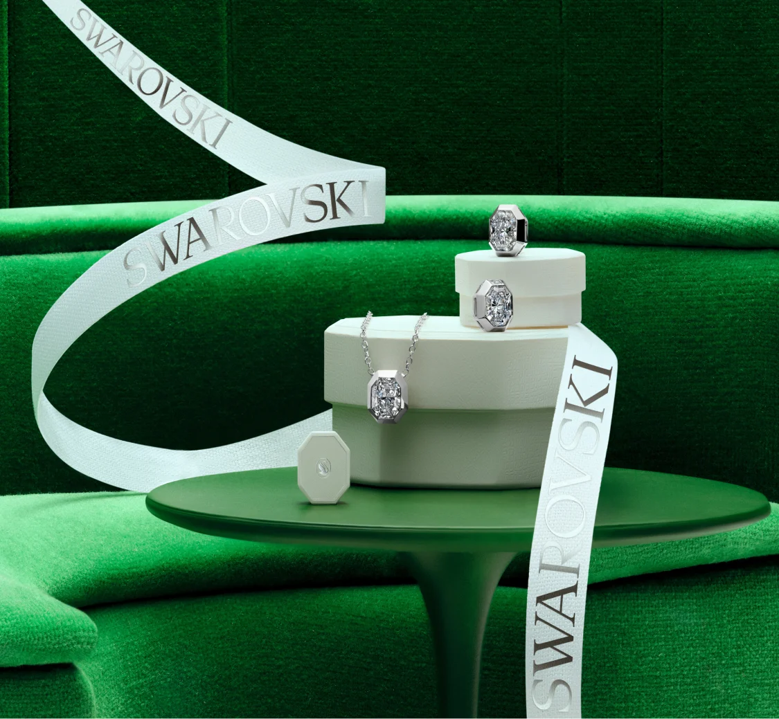 Swarovski Created Diamonds jewelry and white gift boxes on a green background