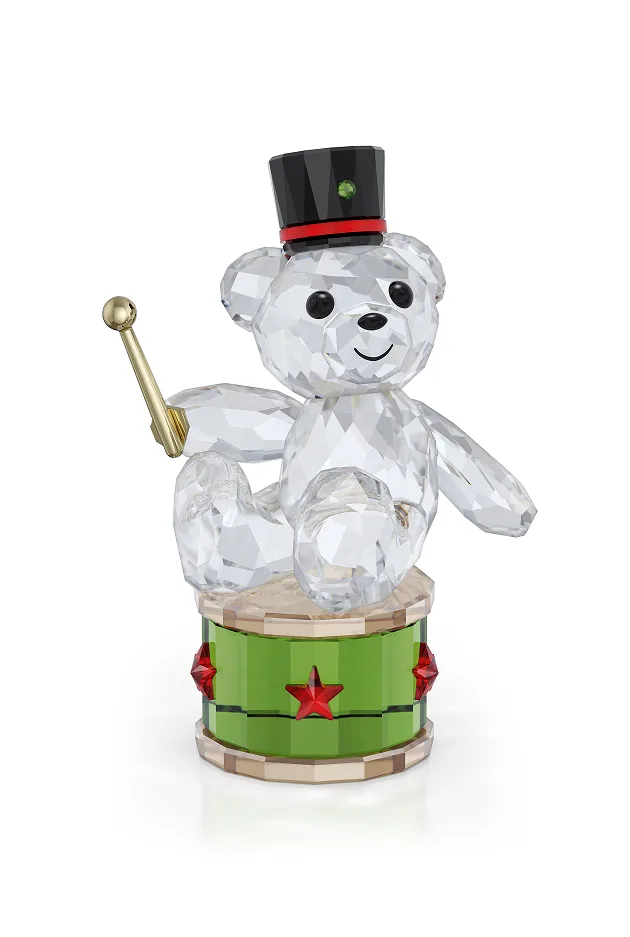 Kris Bear in a hat on a drum, holding a drum stick