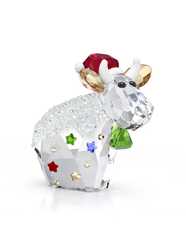 Mo the cow wearing Santa hat and a green cow bell