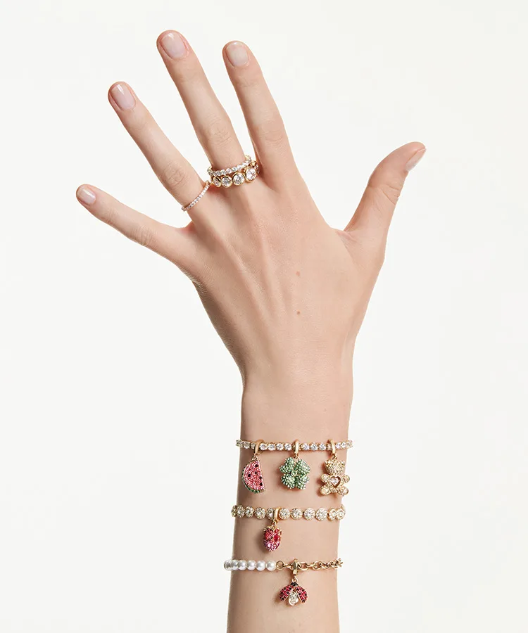 Model's hand with charm bracelets