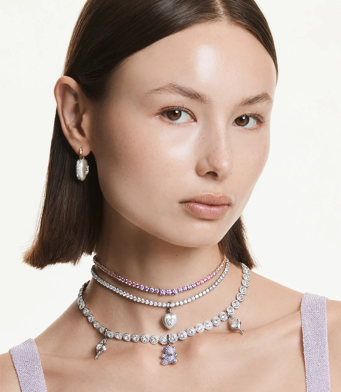 Model wearing Swarovski necklaces and charms