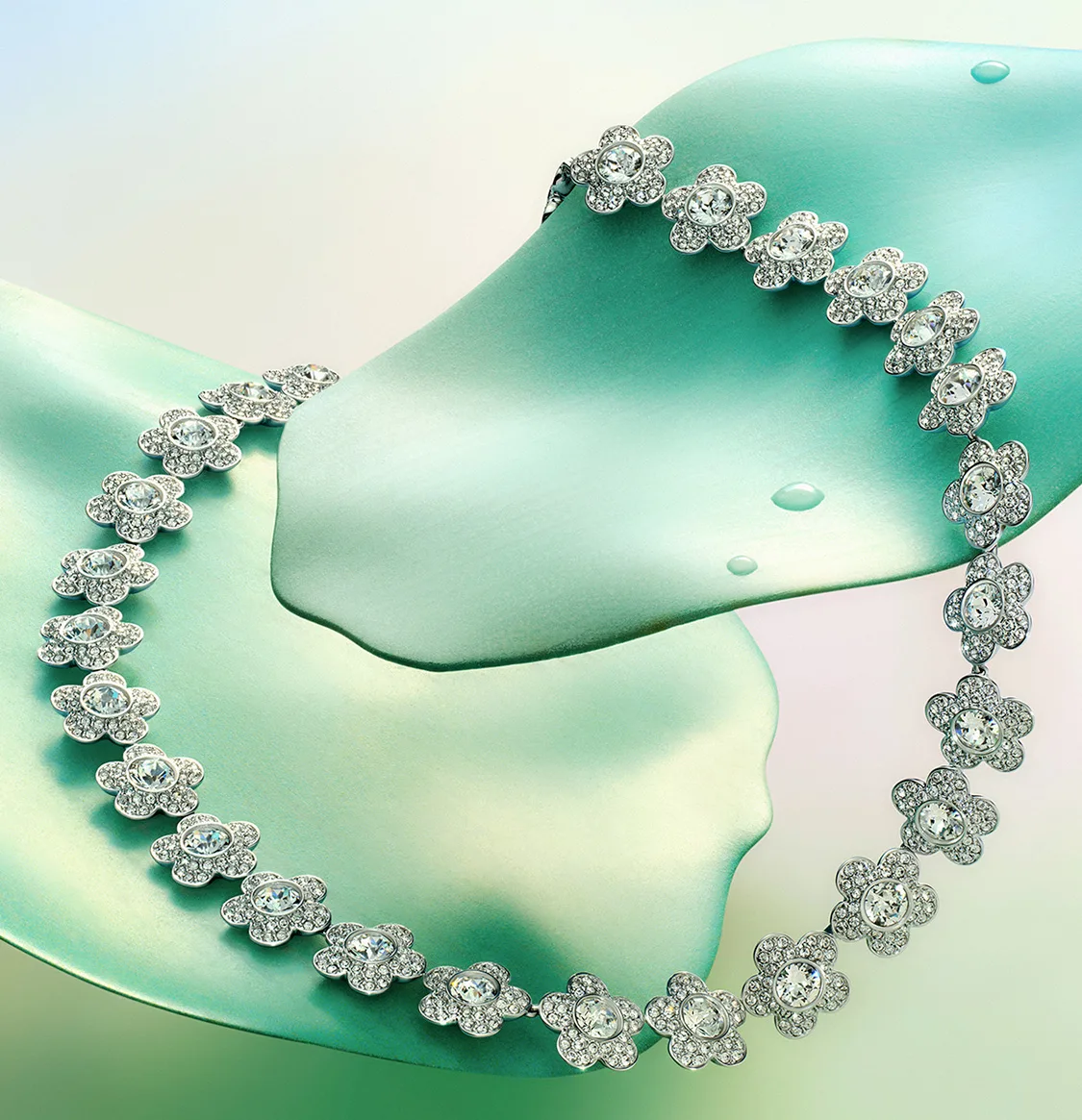 Ariana Grande x Swarovski necklace on green leafs