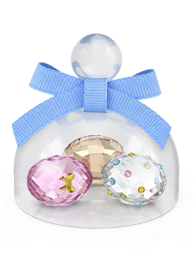 Three colorful eggs under a crystal bell jar