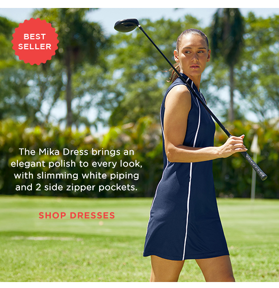 Model in navy blue golf dress with white piping
