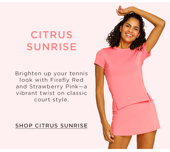 Model in light pink short sleeve active top with side slits and matching light pink active skort 