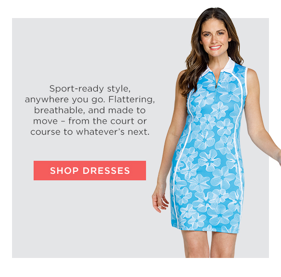 Woman in light blue golf dress with white floral print and white collar and trim detail