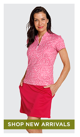 Woman in dark pink and white ditsy floral print short sleeve top and dark pink skort