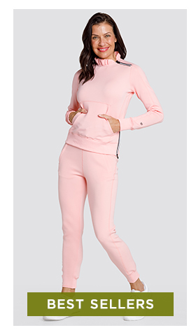 Woman in light pink long sleeve pullover with ruffle collar detail and matching jogger pants