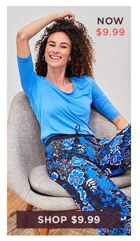 Woman in blue elbow sleeve top and floral pants