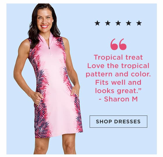 Woman in light pink sleeveless golf dress with palm print pattern at sides