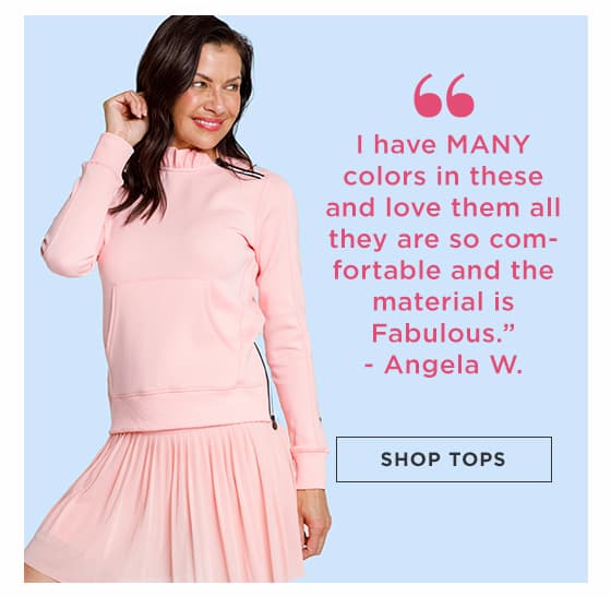 Woman in light pink long sleeve pullover with ruffle collar and zipper and matching pleated skort