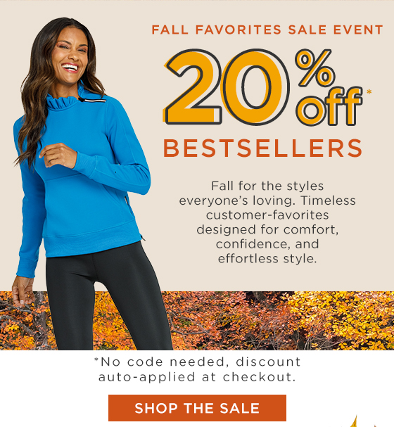 Woman in a blue long sleeve pullover with ruffle collar and zipper detail