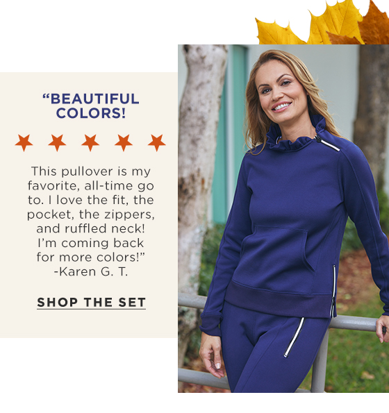 Woman in navy blue long sleeve pullover with ruffle collar and matching joggers