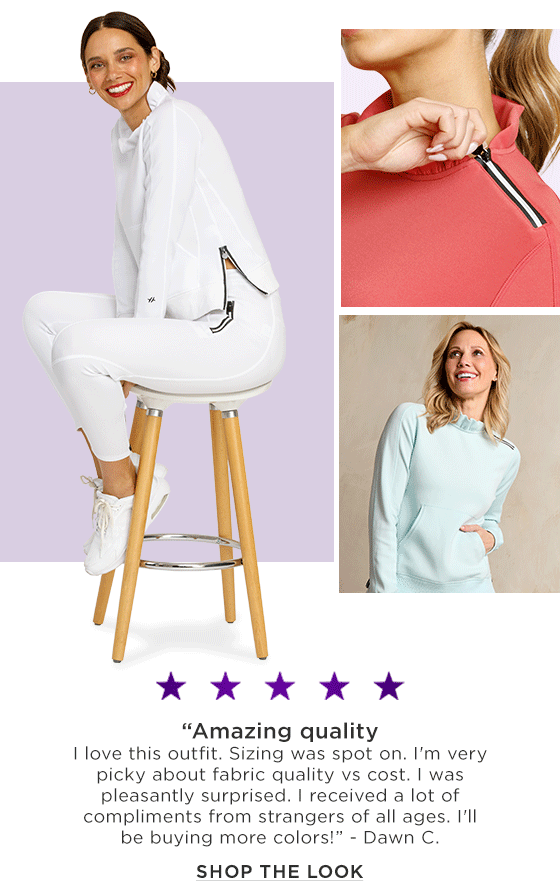 Woman in a white long sleeve pullover with ruffle collar and zipper and matching joggers