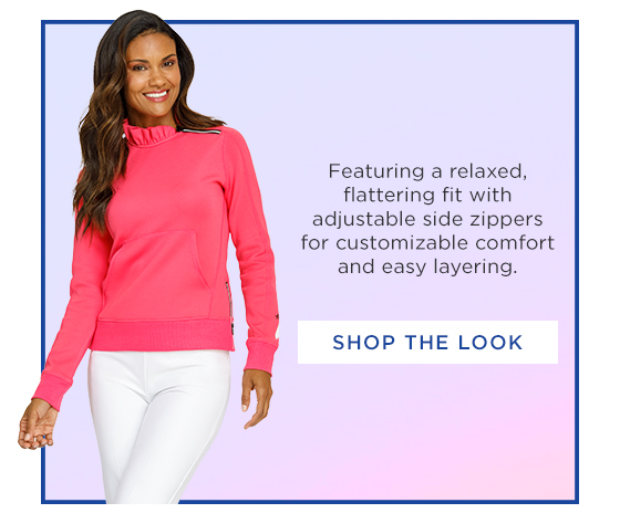 Woman in a bright pink long sleeve pullover with ruffle collar and zipper detail