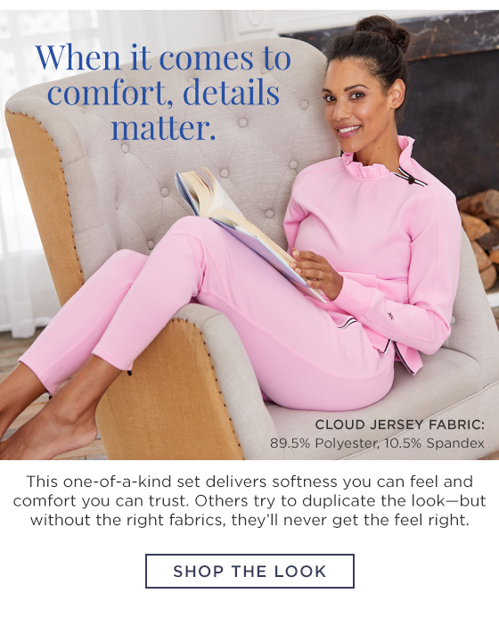 Woman in light pink long sleeve pullover with ruffle collar and zipper and matching jogger pants