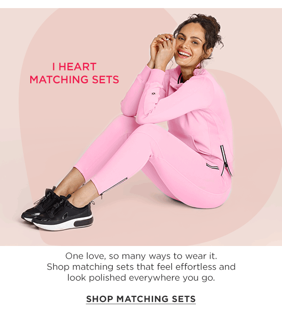Woman in pink long sleeve pullover with ruffle collar and matching jogger pants