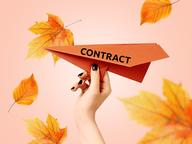 Paper plane with autumn leaves around
