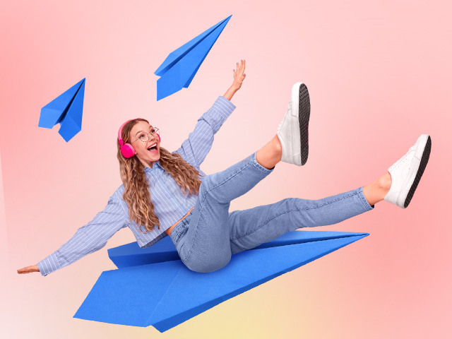 A girl flying on a paper airplane