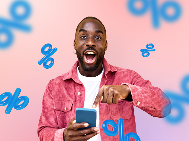 Enthusiastic man about an offer displayed on his phone, sale symbols all around him