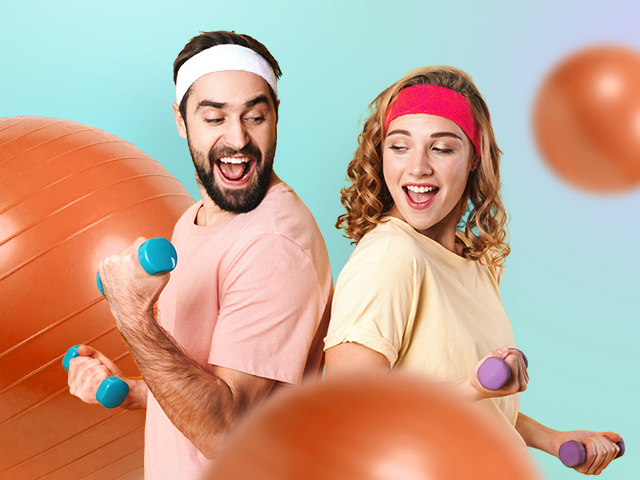 Two people in sports outfits holding dumbbells