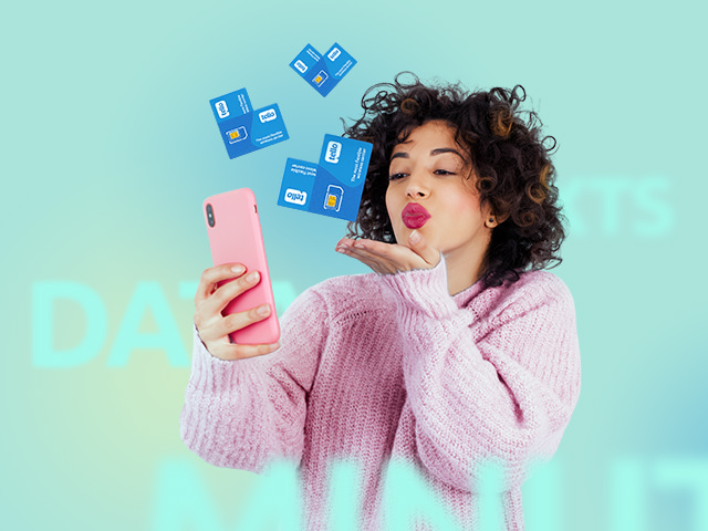 A woman with red lipstick blowing a kiss towards her phone screen, with heart shapes made from Tello sim cards
