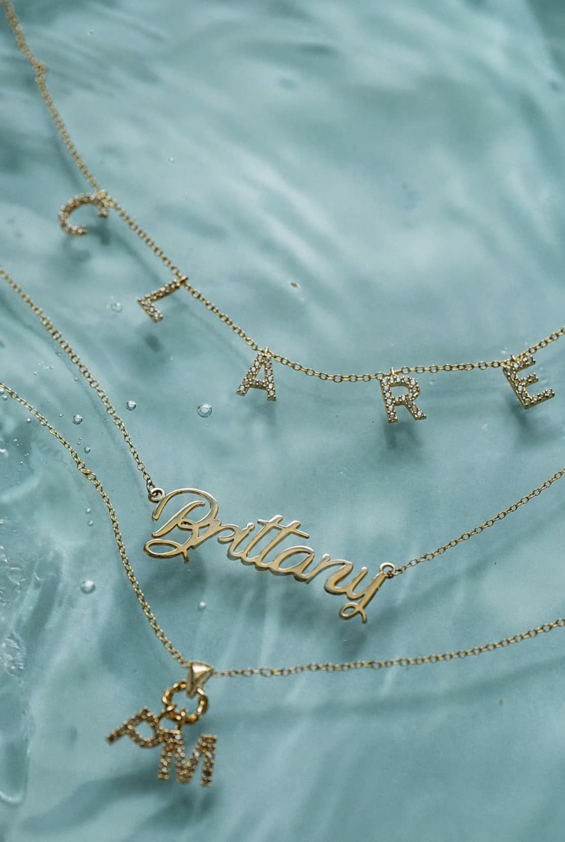 custom necklaces on a green backdrop with 25% off sale copy