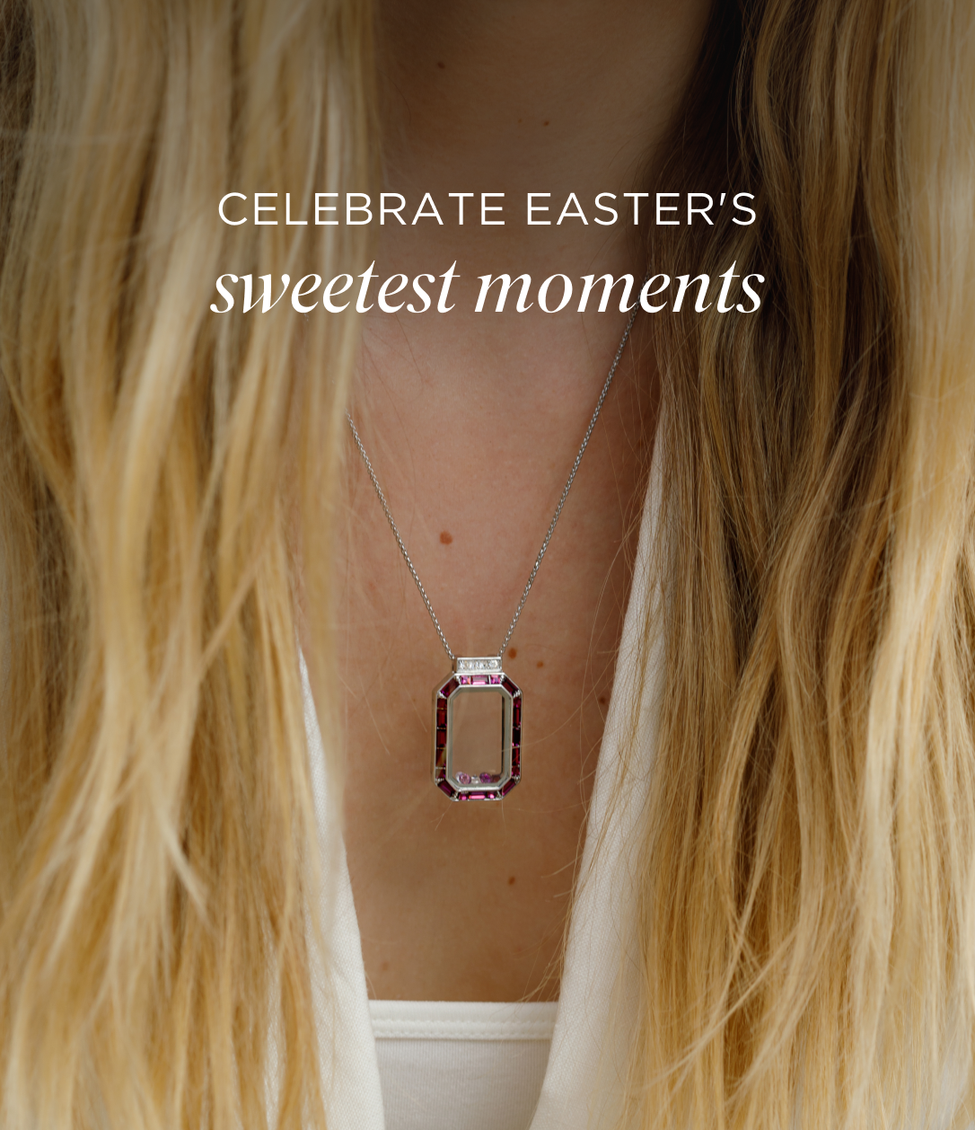 an image of a woman with long blonde hair wearing a necklace with a pink stone