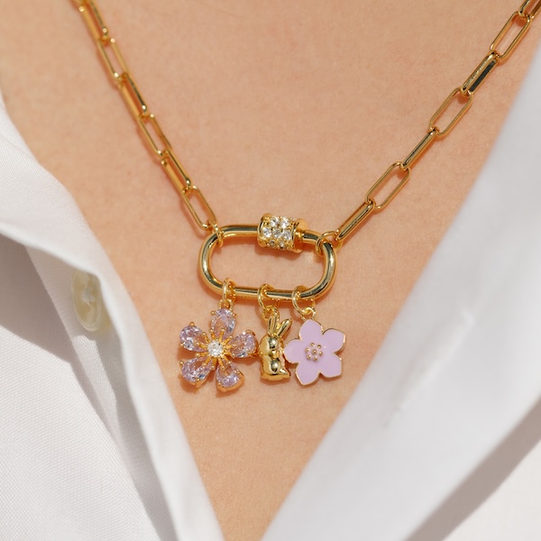 gold carabiner necklace with three charm pendants - two purple flowers and one gold bunny