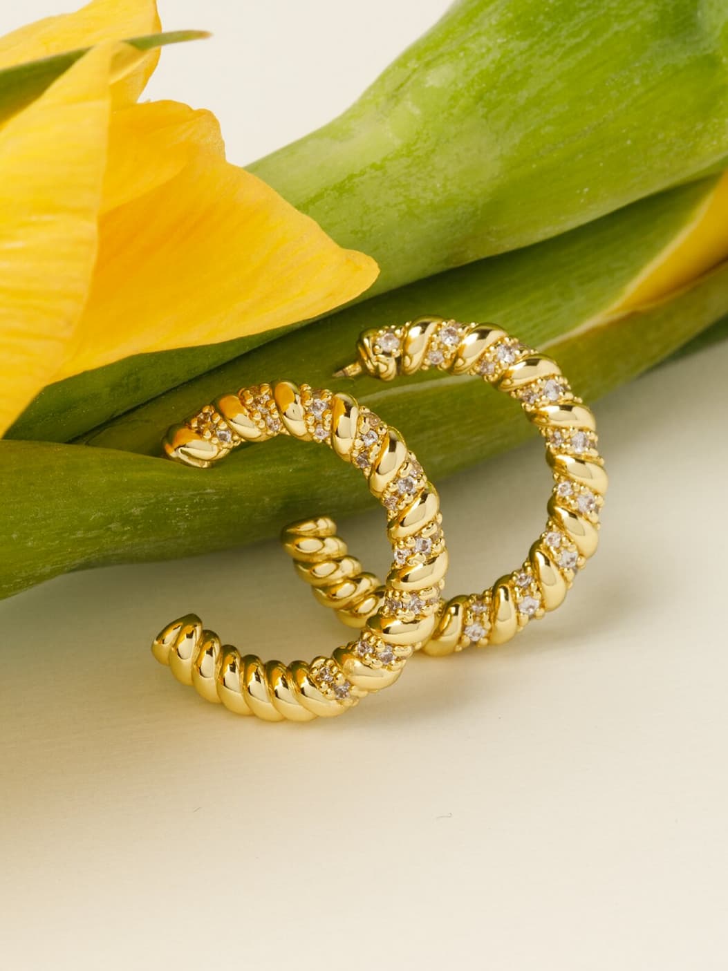 Beauty shot of flowers and Sunlit Twist Hoop Earrings